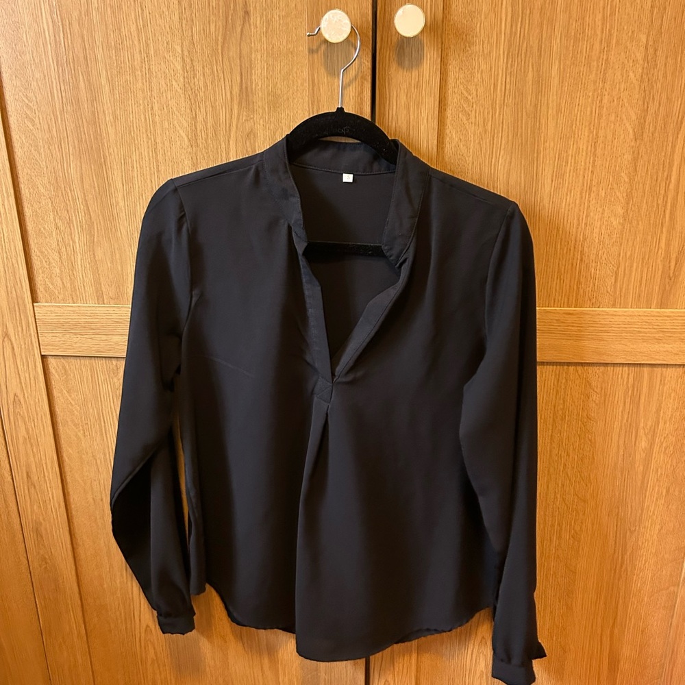 Black long sleeve blouse with a relaxed fit